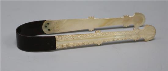 A pair of George III mother of pearl and tortoiseshell sugar tongs